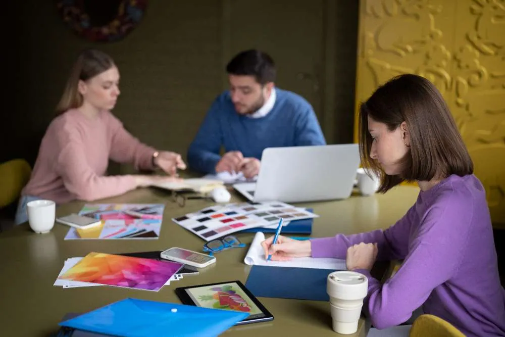 Group of people collaborating on branding and consulting design - branding and consulting in UAE