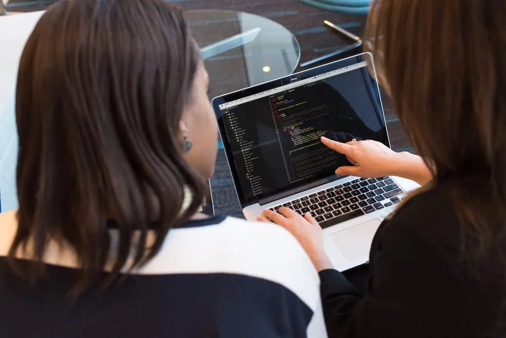 Person explaining code on a computer screen - web design agency in Dubai